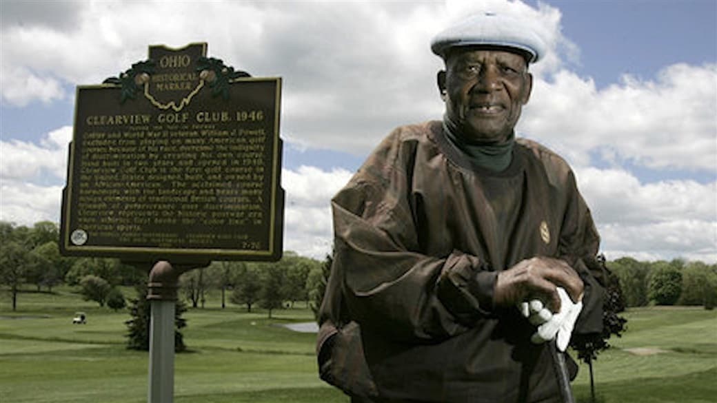 Image of Bill Powell near historical register sign